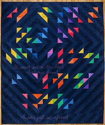 A quilt with full of rainbow colours.